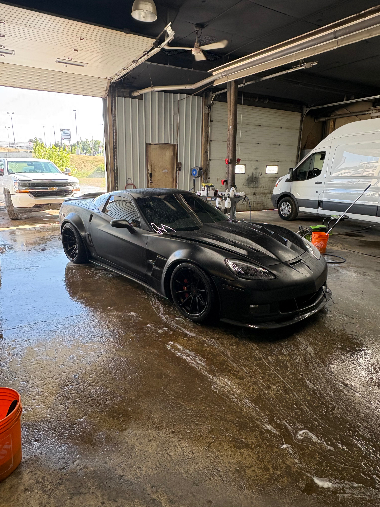 Black Chevrolet Corvette being detailed inside our Caledonia shop