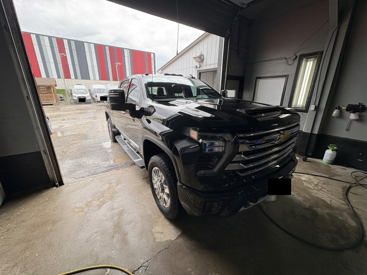 Black sports car detailed in a Caledonia auto detailing workshop